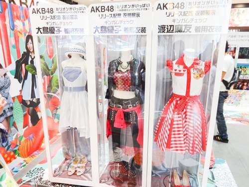 Drie outfits voor videoclip Gingham Check van AKB48 bij Shibuya Tsutaya. De rechter jurk voorzien van een rood-wit ruitjesmotief. (Bron: Wikimedia Commons)